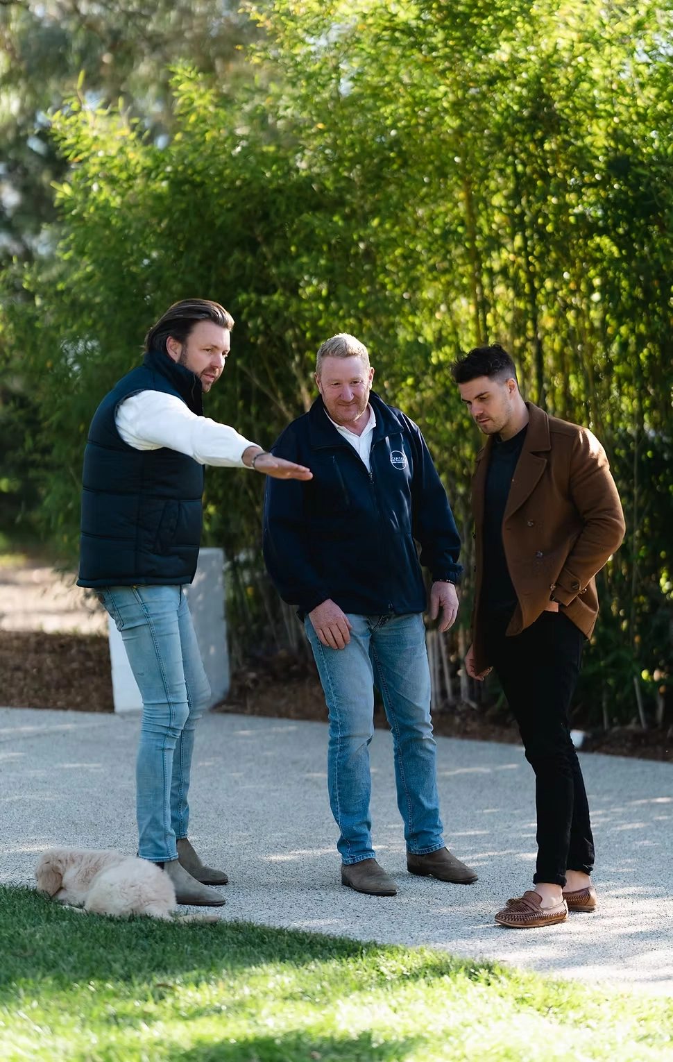 Capital DCM team walking the finished garden on site with the owners and their dog