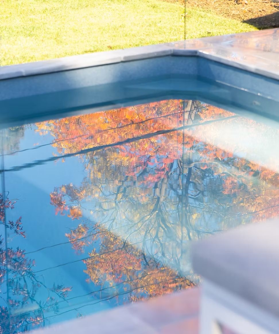 Pool water reflecting autumn foliage in close detail